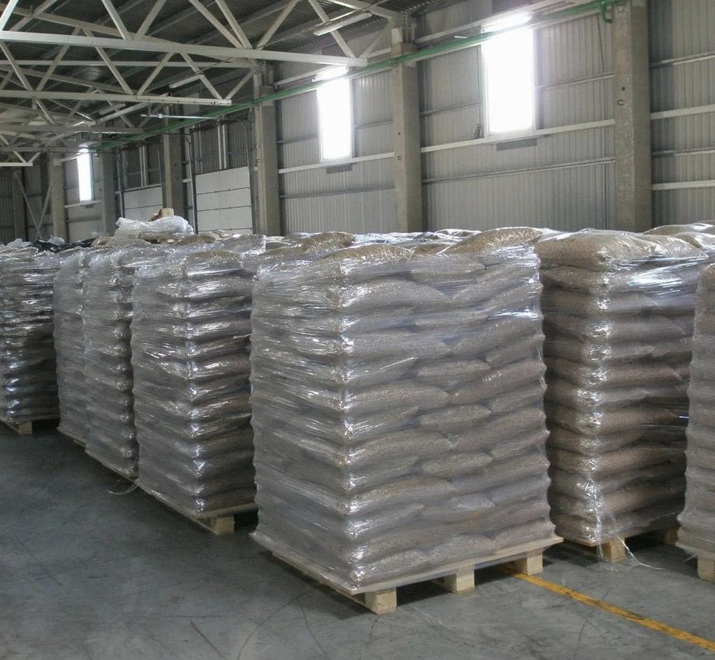 Pallets of bagged wood pellets in storage